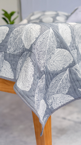 Elegant bedspread collection neatly displayed in a cozy bedroom setting, featuring soft textures, premium fabrics, and inviting neutral tones that blend seamlessly with modern decor.