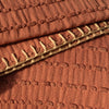 Close-up of orange stripe throw blanket edge