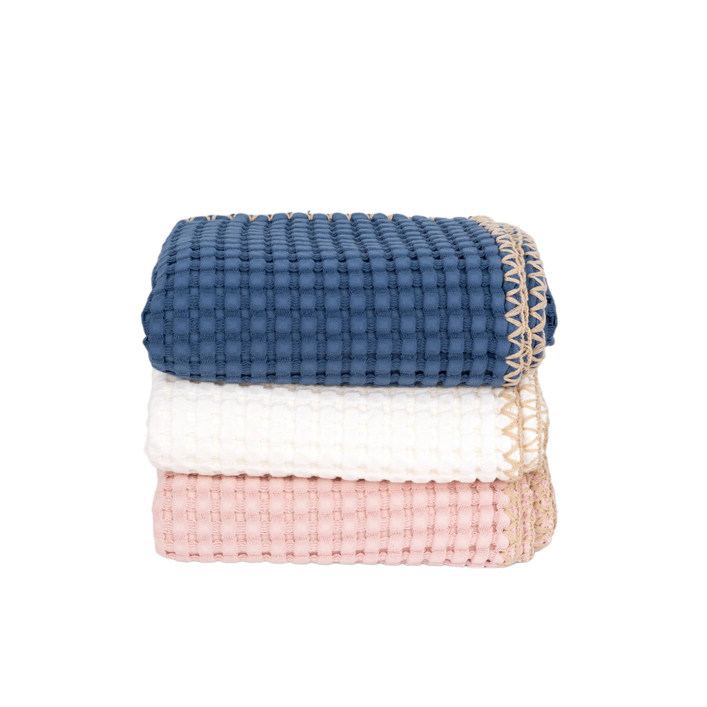 Stack of blue, white, and pink waffle weave baby blankets