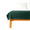 Green stripe throw blanket on bed
