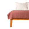Pink stripe throw blanket on bed