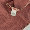 Close-up of pink stripe throw blanket tag