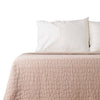 Beige Earthy Cobblestone Blanket on bed with pillows