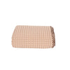 Folded beige waffle throw blanket