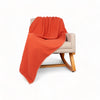 Orange waffle throw blanket on chair