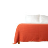 Orange waffle throw blanket on bed